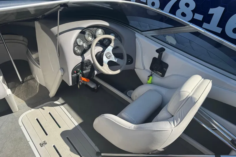 Slide: The Image of 2006 Ebbtide 190 SE boat interior with steering wheel and dashboard controls. - 10