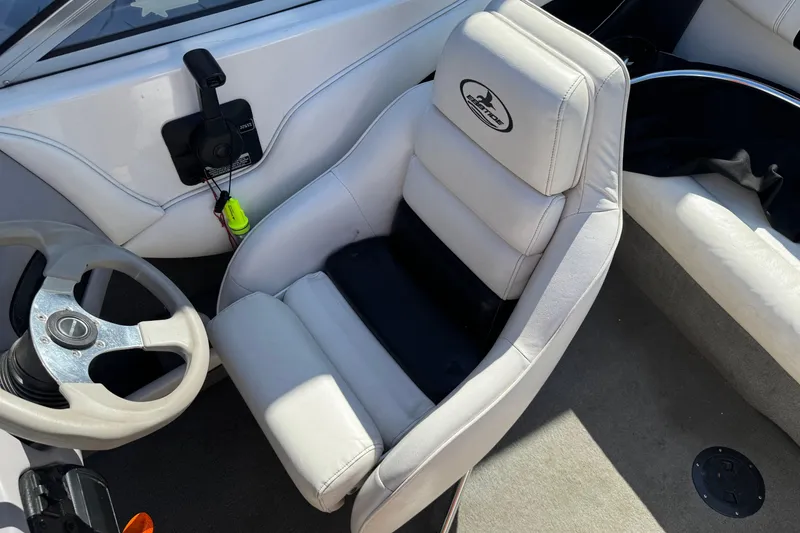 Slide: The Image of Interior of a 2006 Ebbtide 190 SE boat featuring a white captain's seat and steering wheel. - 12