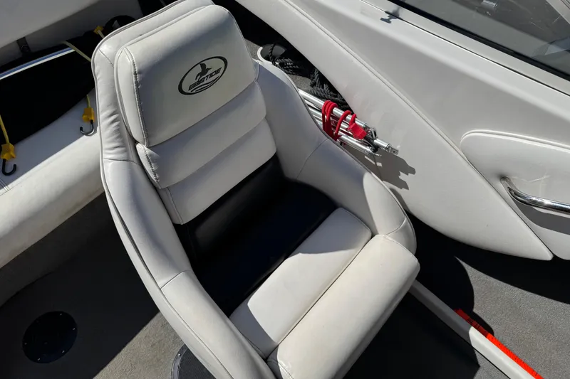 Slide: The Image of 2006 Ebbtide 190 SE boat interior with white cushioned seat and side storage. - 13