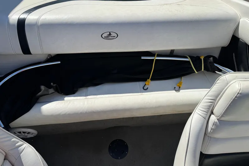 Slide: The Image of 2006 Ebbtide 190 SE boat interior with white seating and storage compartment. - 14