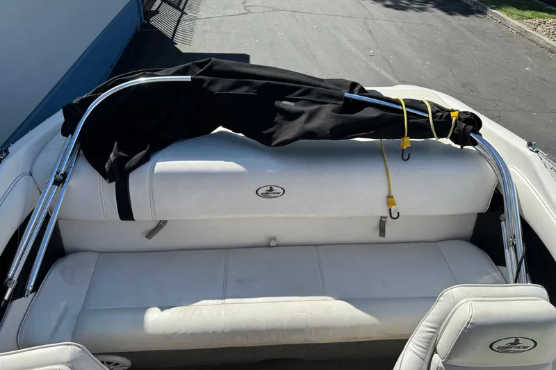 Slide: The Image of 2006 Ebbtide 190 SE boat interior with white seating and folded black canopy. - 15