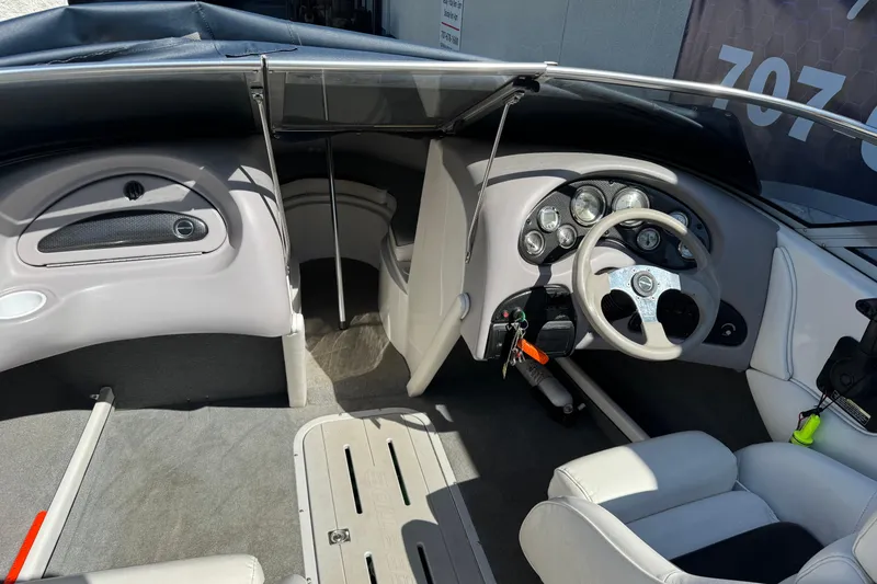 Slide: The Image of Interior of a 2006 Ebbtide 190 SE boat, featuring steering wheel and dashboard controls. - 16