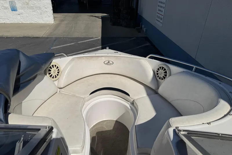 Slide: The Image of 2006 Ebbtide 190 SE boat interior with white seating and speakers. - 17
