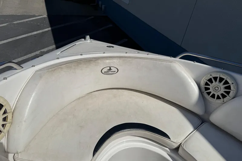 Slide: The Image of 2006 Ebbtide 190 SE boat interior with white seating and speaker detail. - 18