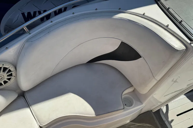 Slide: The Image of 2006 Ebbtide 190 SE boat interior with white cushioned seating and speaker. - 19