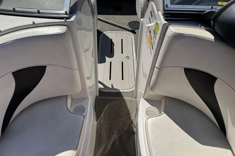 Slide: The Image of Interior of a 2006 Ebbtide 190 SE boat with white seating and cup holders. - 21