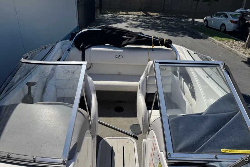 Slide: The Image of 2006 Ebbtide 190 SE boat interior with open windshield and seating area. - 22