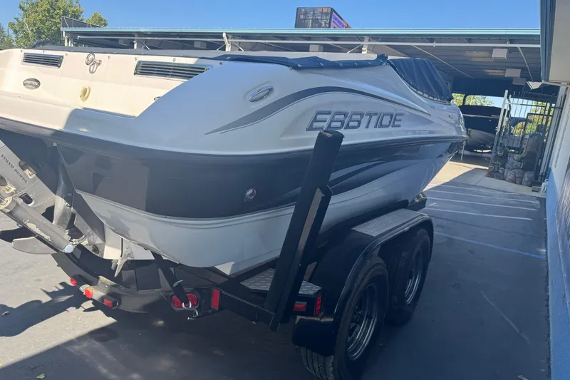 Slide: The Image of 2006 Ebbtide 190 SE boat on trailer, parked outdoors under a canopy. - 5