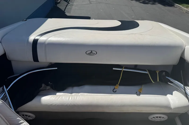 Slide: The Image of 2006 Ebbtide 190 SE boat interior with white seating and black accents. - 9