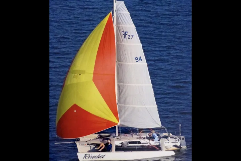 The Image of Sailing Corsair F27 trimaran with colorful spinnaker on open water, 1989 model. - 1