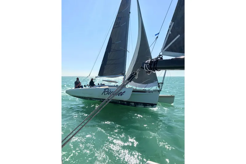 Slide: The Image of Sailing Corsair F27 trimaran from 1989 on open water, sunny day. - 3