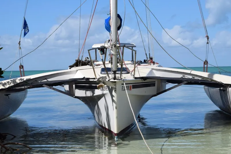Slide: The Image of 1989 Corsair F27 trimaran sailboat on calm water, showcasing sleek design and rigging. - 5