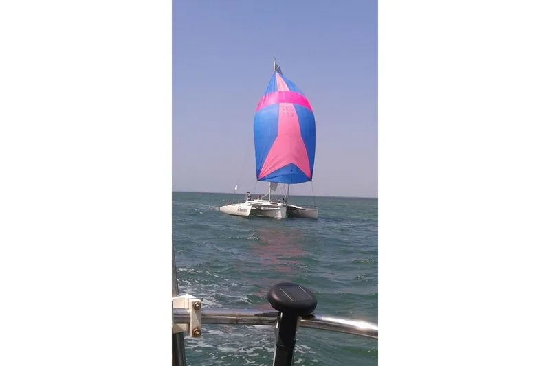 Slide: The Image of Sailing Corsair F27 trimaran with colorful spinnaker on open water, 1989 model. - 6