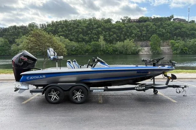 The Image of 2021 Caymas CX 19 boat on trailer by a scenic river backdrop. - 1