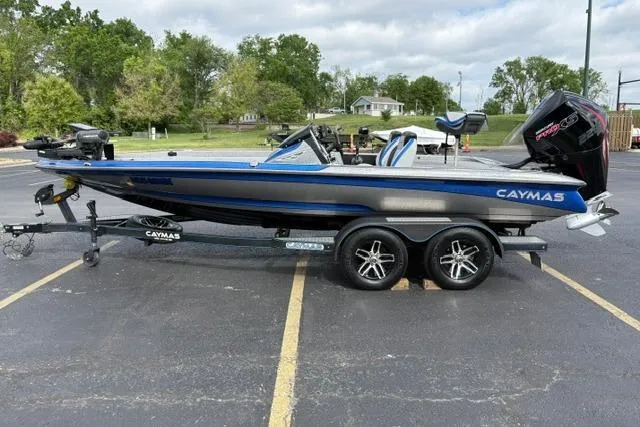 Slide: The Image of 2021 Caymas CX 19 boat on trailer in parking lot, featuring sleek design and modern equipment. - 11