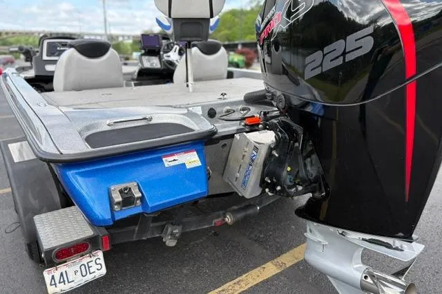 Slide: The Image of 2021 Caymas CX 19 boat with powerful 225 HP outboard motor, parked in a lot. - 14