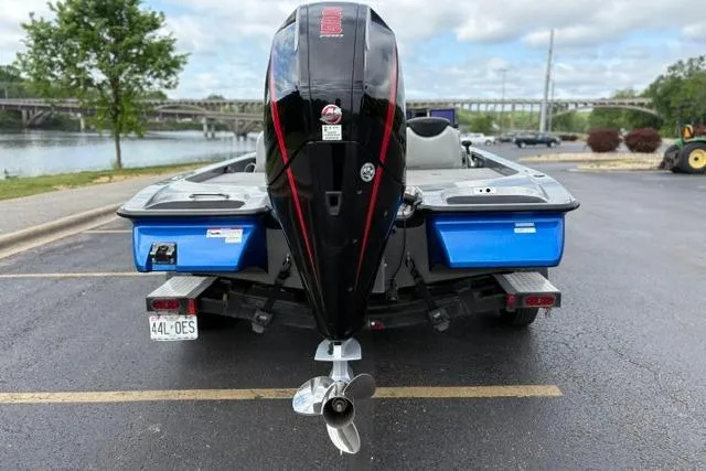 Slide: The Image of 2021 Caymas CX 19 boat with outboard motor, parked near a scenic river. - 15