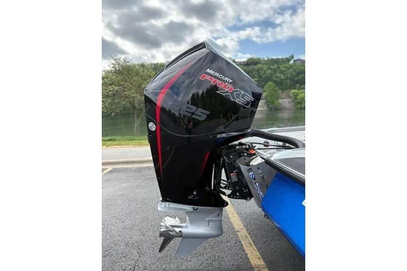 Slide: The Image of 2021 Caymas CX 19 with Mercury Pro XS 225 outboard motor by a lake. - 16