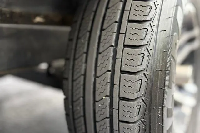 Slide: The Image of Close-up of a 2021 Caymas CX 19 tire with detailed tread pattern. - 26