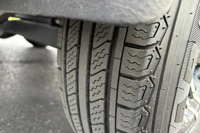 Slide: The Image of Close-up of a 2021 Caymas CX 19 tire tread on a wet surface. - 27