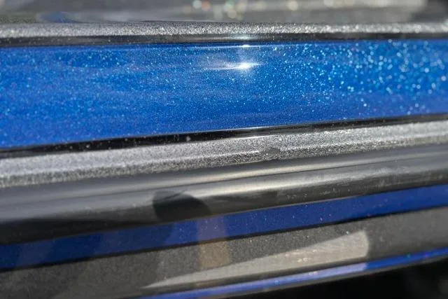 Slide: The Image of Close-up of 2021 Caymas CX 19 boat's blue metallic finish with sparkling detail. - 28