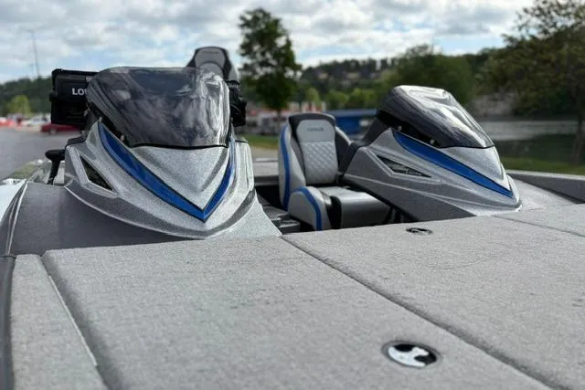 Slide: The Image of 2021 Caymas CX 19 boat with sleek design and dual consoles, set against a scenic backdrop. - 32