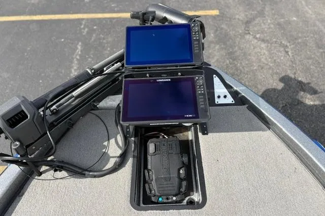 Slide: The Image of 2021 Caymas CX 19 boat dashboard with dual Lowrance fish finders and trolling motor. - 35