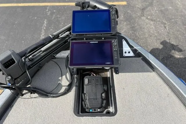 Slide: The Image of 2021 Caymas CX 19 boat with dual Lowrance fish finders and trolling motor on deck. - 36
