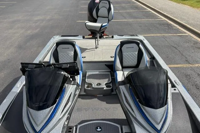Slide: The Image of 2021 Caymas CX 19 boat interior with dual seats and console, parked on asphalt. - 39