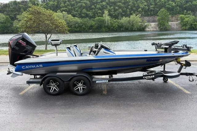 Slide: The Image of 2021 Caymas CX 19 boat on trailer by a scenic lake. - 4