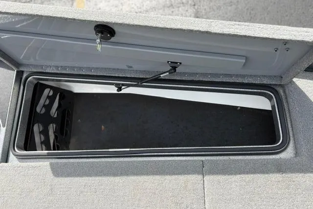 Slide: The Image of Open storage compartment in 2021 Caymas CX 19 boat, featuring secure latch and spacious interior. - 41