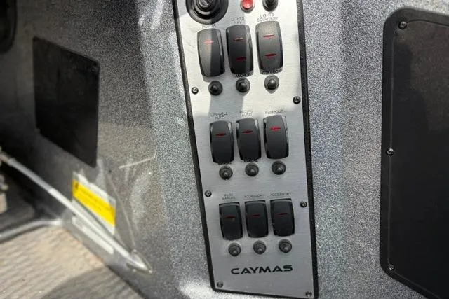 Slide: The Image of Control panel of 2021 Caymas CX 19 boat with labeled switches and buttons. - 47