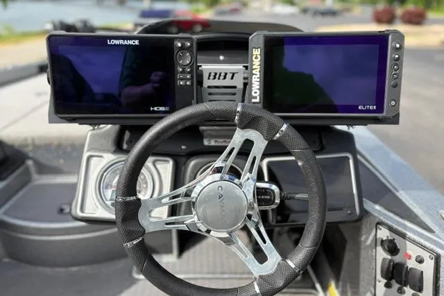 Slide: The Image of 2021 Caymas CX 19 boat dashboard with dual Lowrance fish finders and steering wheel. - 49
