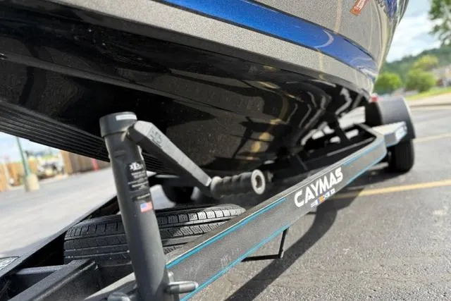 Slide: The Image of 2021 Caymas CX 19 boat on trailer, close-up view of hull and support. - 57