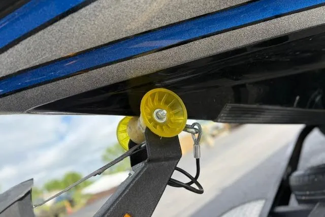 Slide: The Image of 2021 Caymas CX 19 boat trailer with yellow roller and blue hull detail. - 58