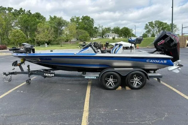 Slide: The Image of 2021 Caymas CX 19 boat on trailer, blue and silver, parked outdoors. - 6
