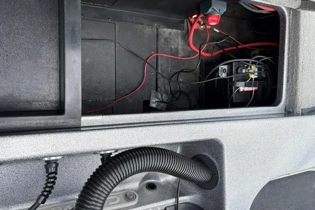 Slide: The Image of 2021 Caymas CX 19 boat battery compartment with wiring and components. - 65