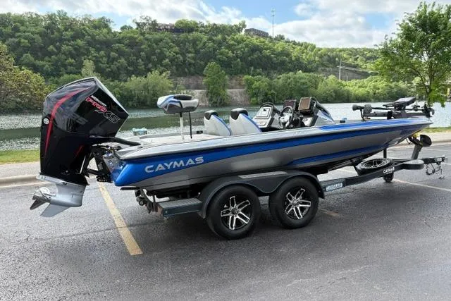 Slide: The Image of 2021 Caymas CX 19 boat on trailer by a scenic river. - 8