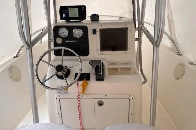 Slide: The Image of 2001 Sea Pro 190 Center Console boat interior with steering wheel and navigation equipment. - 11