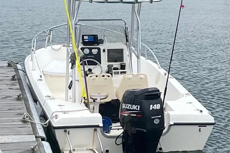 Slide: The Image of 2001 Sea Pro 190 Center Console boat docked, featuring Suzuki 140 outboard motor. - 2