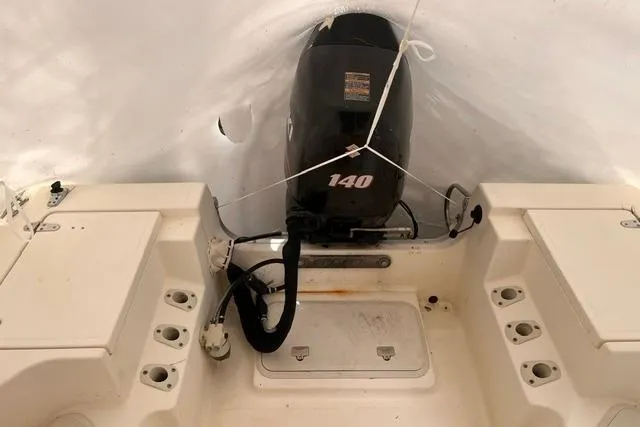 Slide: The Image of 2001 Sea Pro 190 Center Console boat with 140 HP engine, covered and stored. - 5