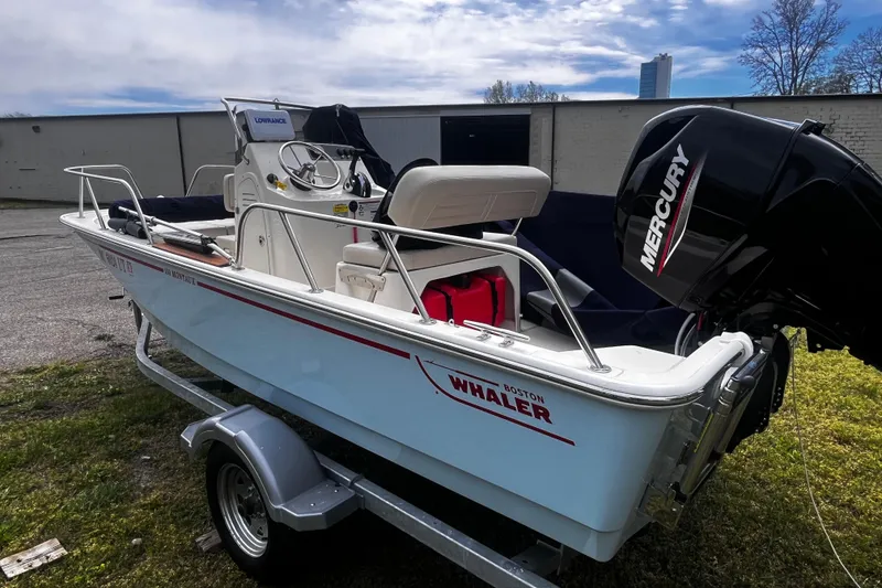 Slide: The Image of 2022 Boston Whaler 150 Montauk boat with Mercury engine on trailer. - 2