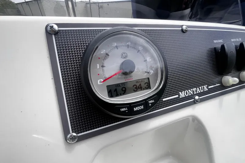 Slide: The Image of Close-up of 2022 Boston Whaler 150 Montauk dashboard with tachometer and controls. - 5