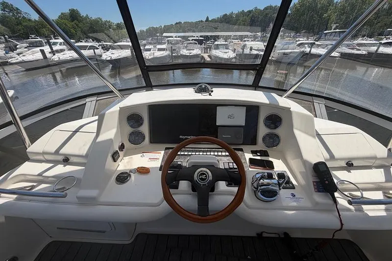 Slide: The Image of Interior view of 2008 Sea Ray 36 Sedan Bridge yacht cockpit with white seating. - 10