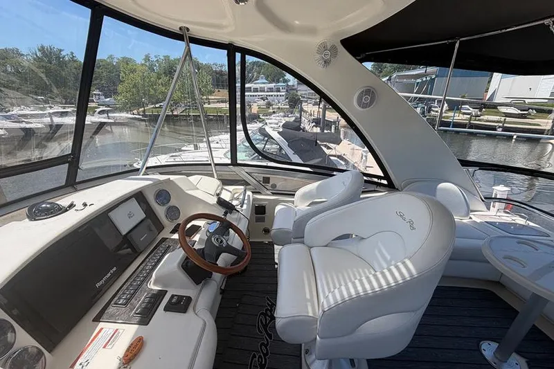 Slide: The Image of Helm of 2008 Sea Ray 36 Sedan Bridge with marina view in background. - 11