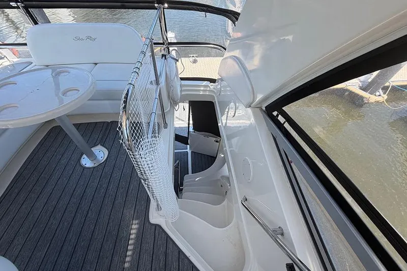Slide: The Image of 2008 Sea Ray 36 Sedan Bridge interior with seating and table, overlooking water. - 12