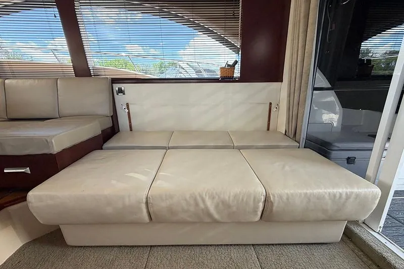 Slide: The Image of Interior of 2008 Sea Ray 36 Sedan Bridge with beige seating and large windows. - 16