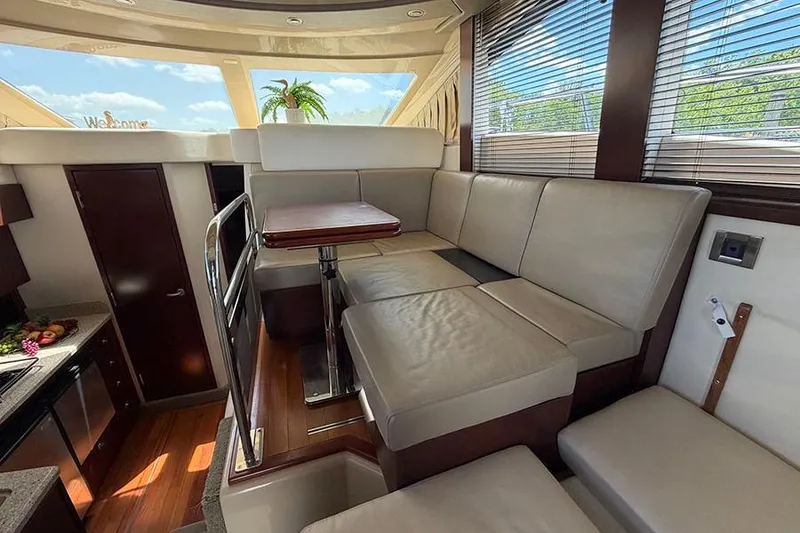 Slide: The Image of Interior of 2008 Sea Ray 36 Sedan Bridge with beige seating and wooden accents. - 17