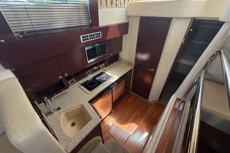 Slide: The Image of Luxurious 2008 Sea Ray 36 Sedan Bridge yacht interior with modern kitchen amenities. - 18
