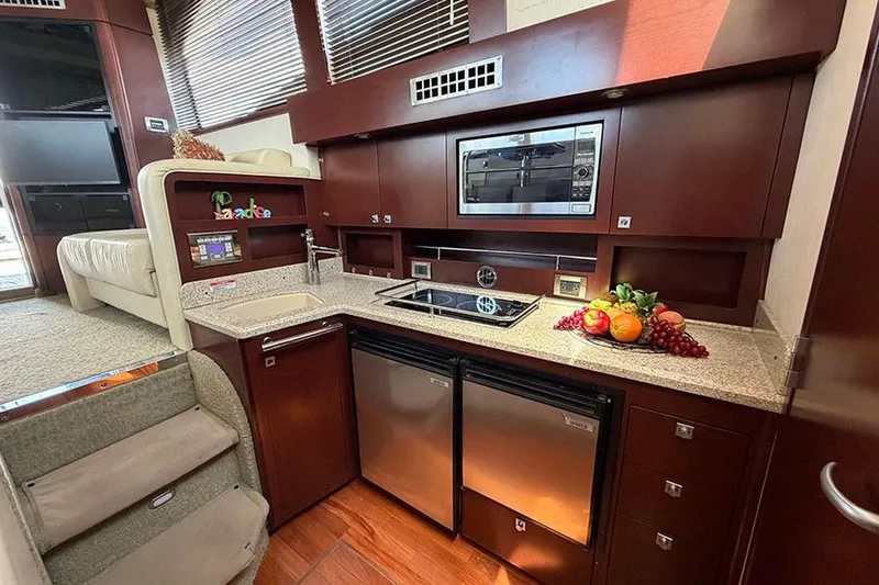 Slide: The Image of Luxurious 2008 Sea Ray 36 Sedan Bridge yacht kitchen with modern appliances and elegant wood cabinetry. - 19